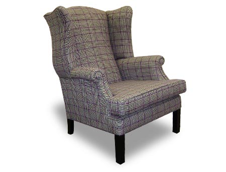 Edwin Wing Armchair. High backed winged lounge chair with rounded arms and long square dark wooden legs.