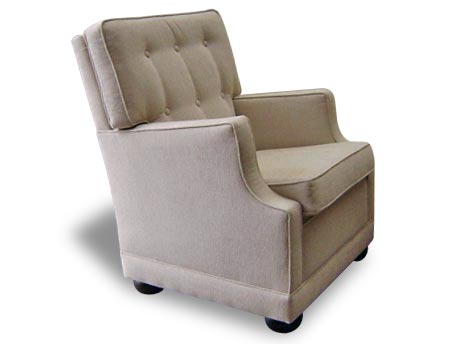 Peyton Square Armchair upholstered chair with buttons on the high back and wooden feet.