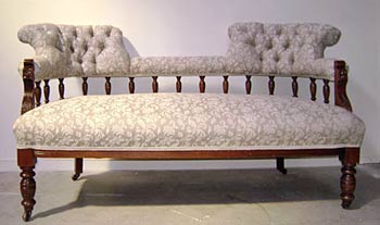 ornate sofa with turned wooden legs and back reupholstered by the skilled upholstery company Wilson and Nicholson